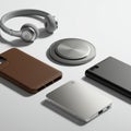 A collection of modern tech accessories on a light background, including gray over- Royalty Free Stock Photo