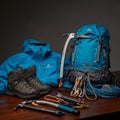 A collection of mountaineering equipment is displayed on a wooden surface. It Royalty Free Stock Photo