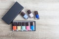 Collection of multi-colored bottles of nail polish. Layout for design on a gray background