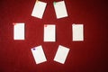 Collection of note papers pinned on a red board ready for filling in quotes. Royalty Free Stock Photo