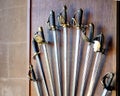 Collection of old antique sword,rapier and cutlass handles displayed on a wooden panel