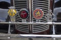 A collection of old motor badges on the front of a vintage car in Suffolk