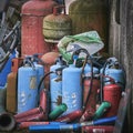 Old fire extinguishers stacked together outside