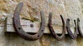 Collection of old rusty horseshoes hanging on a rack