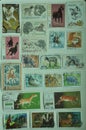 Collection of old stamps on a board Royalty Free Stock Photo
