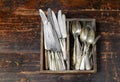 Collection of old vintage cutlery in a wooden tray Royalty Free Stock Photo