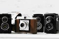 Collection old vintage retro photo cameras on white wooden background. top view, medium format Royalty Free Stock Photo