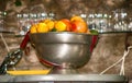 Collection of oranges and lemons in a metal bowl