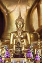 Collection of ornate, colorful Buddha statues with intricate gold detailing