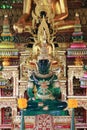 Collection of ornate, colorful Buddha statues with intricate gold detailing