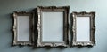 A collection of ornate silver frames against a muted grey wall , grey, image, artwork Royalty Free Stock Photo