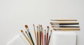 A collection of paintbrushes is displayed on a white surface. The brushes vary in size Royalty Free Stock Photo