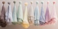 Collection of pastel colored dusters hanging in a row transforms act of dusting into an artistic and aesthetically