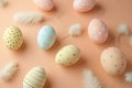 A collection of patterned pastel colour Easter eggs adorned with soft feathers, set against a peach backdrop, exudes a Royalty Free Stock Photo