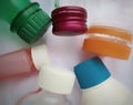 A collection of plastic bottles and caps with various shapes and colors