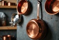 Copper cookware hanging on a rustic kitchen wall, showcasing elegance and style Royalty Free Stock Photo