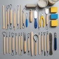 Collection of pottery and sculpting tools arranged on a gray surface Royalty Free Stock Photo