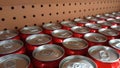 Collection of red aluminum beverage cans arranged on shelves with pegboard background Royalty Free Stock Photo