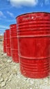 a collection of red drums on the ground with a blue sky Royalty Free Stock Photo