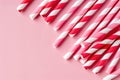 Collection of red and white striped drinking straws on a pink background Royalty Free Stock Photo