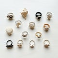 A collection of rings and seashells arranged on a light wooden surface Royalty Free Stock Photo