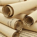 A collection of rolled parchment scrolls with a textured, beige surface lies in a close Royalty Free Stock Photo