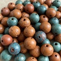 A collection of round beads in brown and teal tones, featuring a textured surface with Royalty Free Stock Photo
