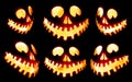 Collection of scary Halloween carved pumpkin Jack o lantern faces glowing red and yellow eerily on black