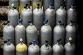 Collection of scuba diving air oxygen tanks waiting lined up. Royalty Free Stock Photo