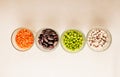 Collection set of various dried legumes in glass cups arranged horizontally green peas, red lentils, red beans, white beans close- Royalty Free Stock Photo