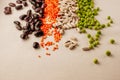 Collection set of various dried legumes laid out in a horizontal line, chaotic order: red lentils,green peas, red beans, white Royalty Free Stock Photo