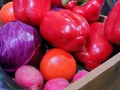 A collection of several colorful fruits and vegetables, sitting in a wooden box. Royalty Free Stock Photo