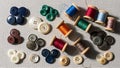 Collection of Sewing Buttons and Thread Spools on a Light Gray Surface Royalty Free Stock Photo