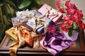 Collection of silk scarves, jewelry box and bouquet of orchids. Generative AI Royalty Free Stock Photo