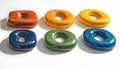 Assorted colorful torus shapes with central hole on white background Royalty Free Stock Photo