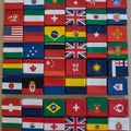 A collection of small boxes is adorned with various national flags, arranged in a grid Royalty Free Stock Photo