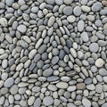 A collection of smooth rounded grey pebbles of varying sizes and hues Royalty Free Stock Photo
