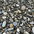 A collection of smooth rounded pebbles covers the ground varying in size Royalty Free Stock Photo