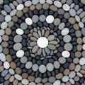 A collection of smooth, rounded stones arranged in a circular design. The centerpiece is a white Royalty Free Stock Photo