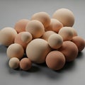 A collection of smooth, spherical objects in various sizes are gathered on a neutral Royalty Free Stock Photo