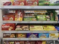 A collection of snacks or biscuits arranged on a shelf at the Indomaret Indonesia minimarket
