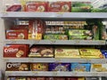 A collection of snacks or biscuits arranged on a shelf at the Indomaret Indonesia minimarket