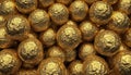 A collection of spherical objects, resembling golf balls, are covered in crinkled gold