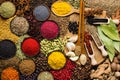 Colorful spices and herbs background. Large set seasonings scattered on table