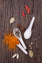 Collection of spicy ingredients on wooden background. Royalty Free Stock Photo
