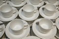 Empty cups and saucers with teaspoons.