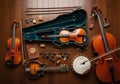 A violin in an open case, a cello, a smaller viola, a mandolin, and a Royalty Free Stock Photo