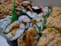 a collection of sushi with various kinds of toppings