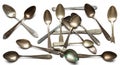 A collection of tarnished, silver teaspoons scattered randomly. The spoons vary in Royalty Free Stock Photo