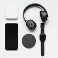 A collection of tech gadgets neatly arranged on a white background. Includes a black